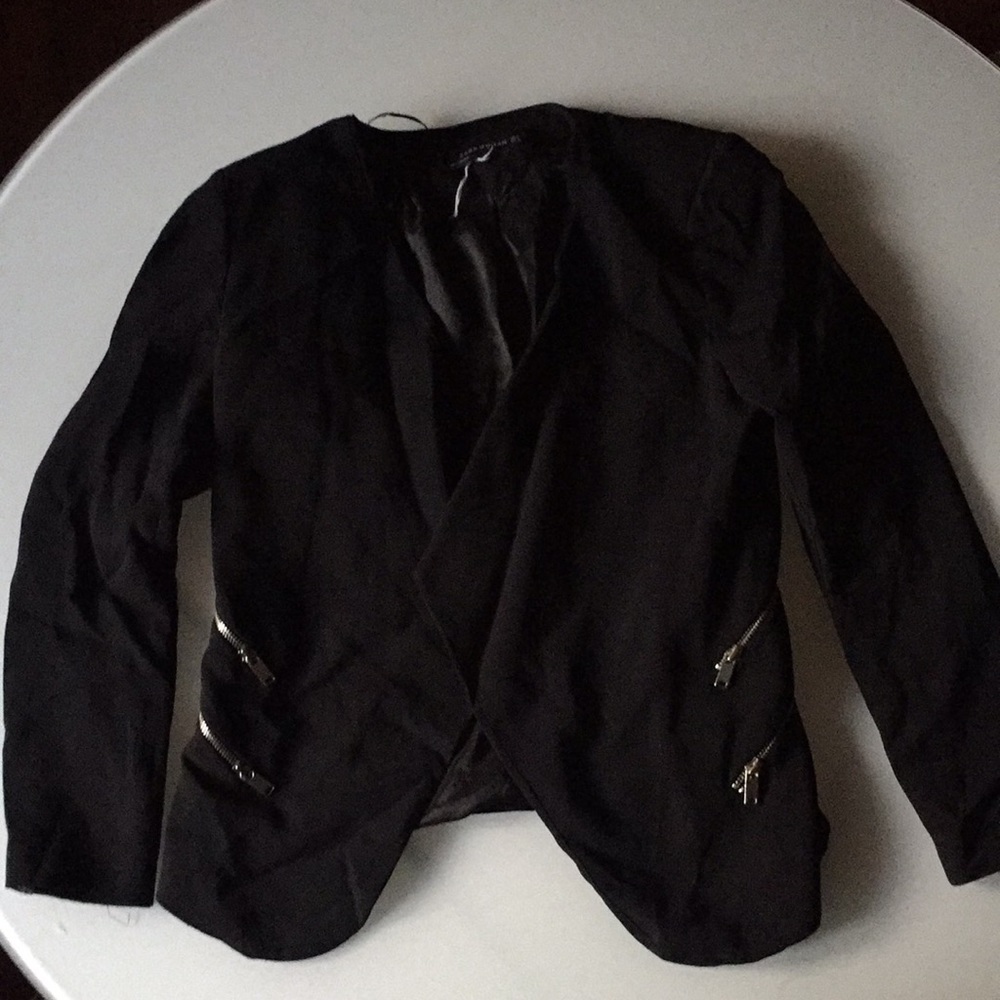 Black blazer with double zipper on each side.